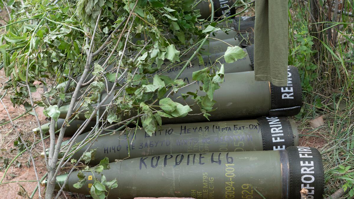 U.S.-supplied M777 howitzer shells lie on the ground to fire at Russian positions in Ukraine's...