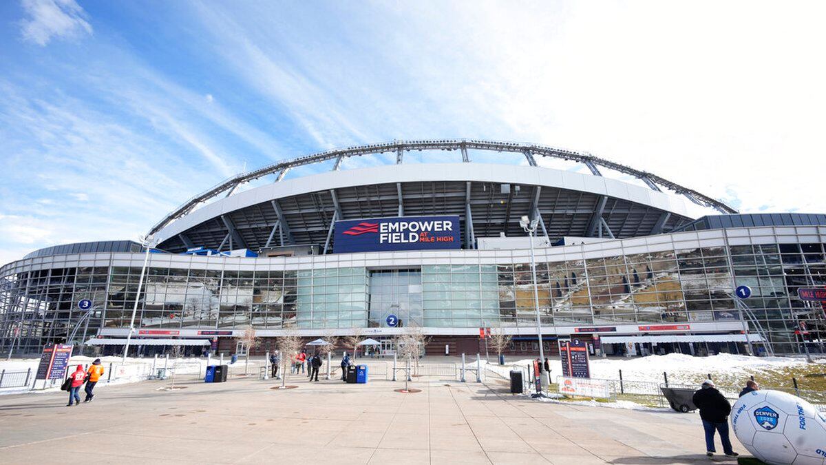 FILE - Fans tailgate outside of Empower Field at Mile High before an NFL football game between...