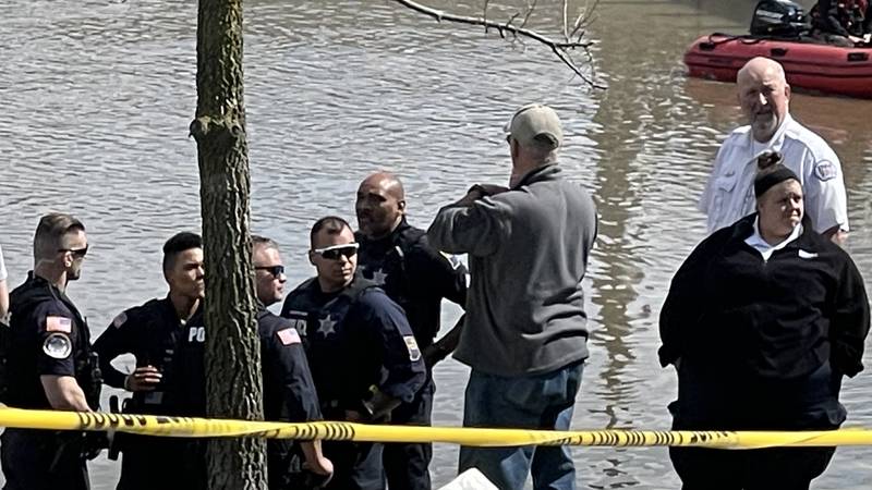 Crews work to pull a body from St. Marys River at Promenade Park on Sunday