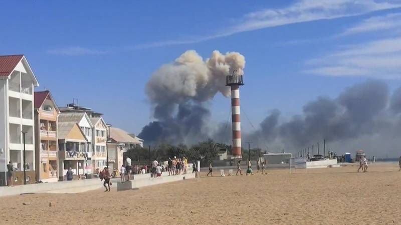 Explosions are seen from the beach in Crimea on Tuesday.