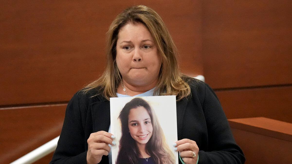 Jennifer Montalto holds a picture of her daughter, Gina, before giving her victim impact...