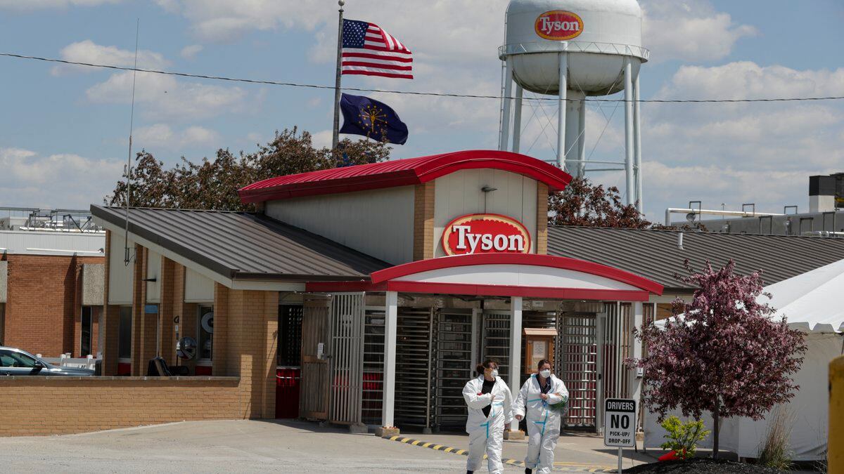 FILE - In this May 7, 2020 file photo, workers leave the Tyson Foods pork processing plant in...
