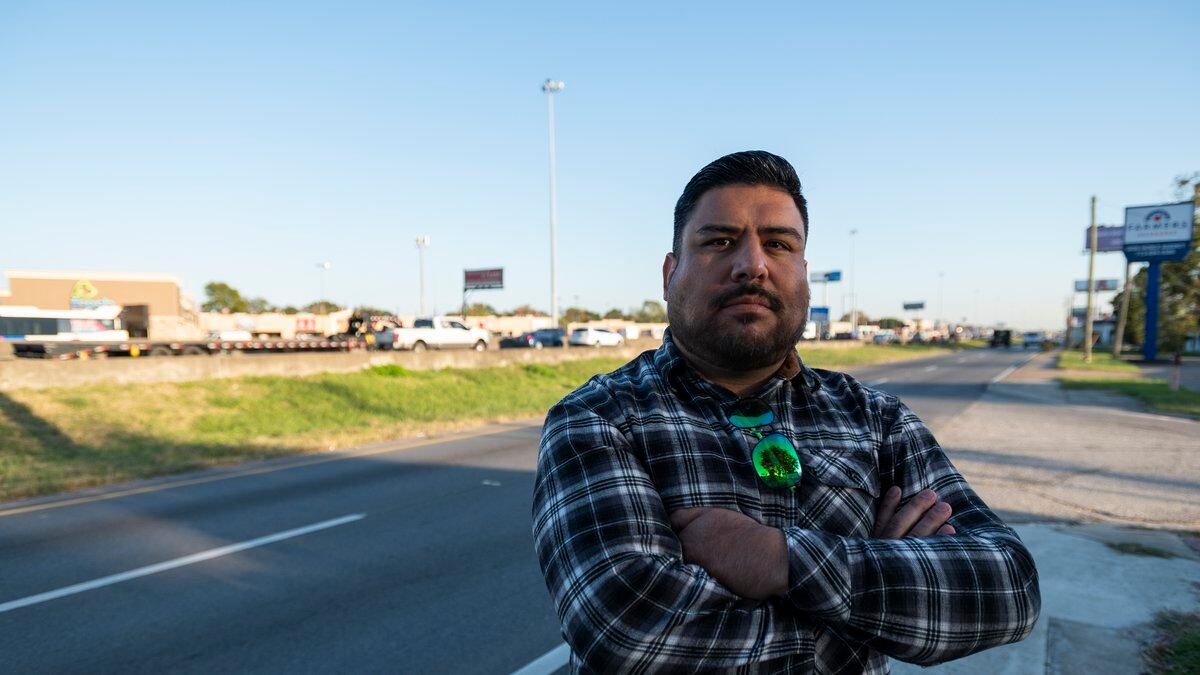 Fabian Ramirez stands next to Interstate 45 while traffic flows behind him Friday, Nov. 19,...