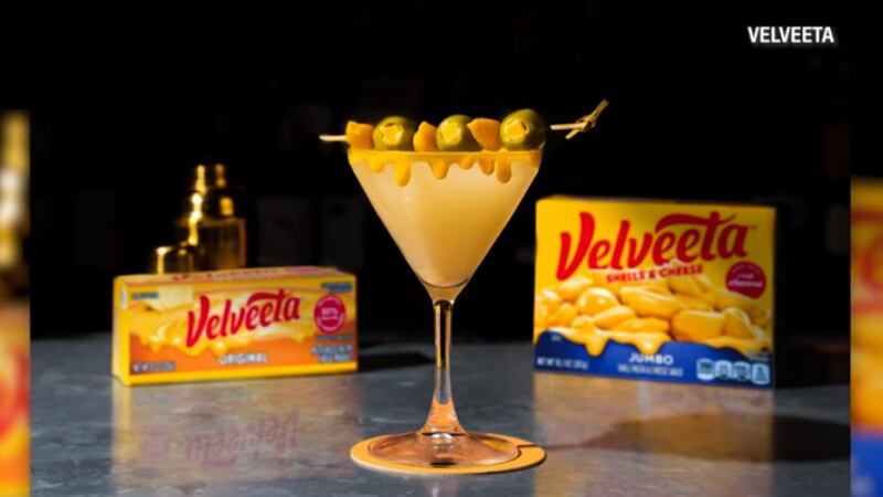 The veltini is garnished with a cheese drip and a cocktail pick of Velveeta-stuffed olives and...