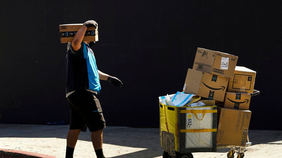 FILE - An Amazon worker delivers boxes in Los Angeles on Oct. 1, 2020. Amazon said Wednesday,...