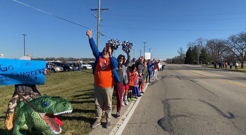 Carroll Charger fans lined Carroll Road Friday afternoon as the football team left Carroll High...