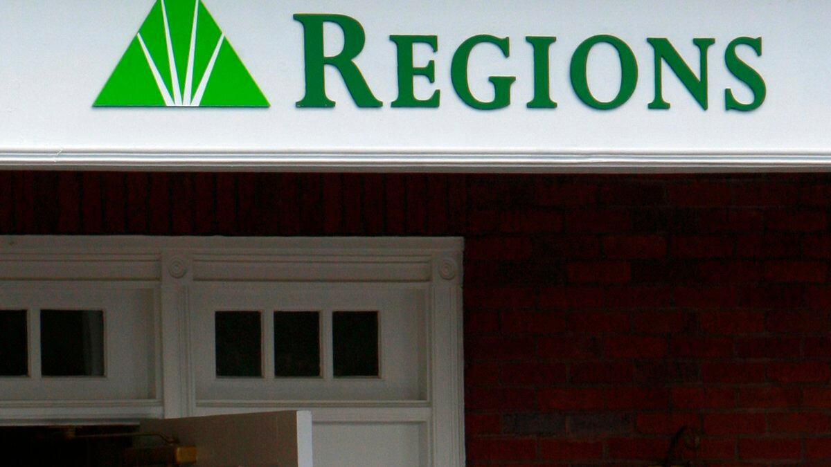 FILE - The logo for Regions Bank is seen above a branch's entrance in Roswell, Ga., Thursday,...