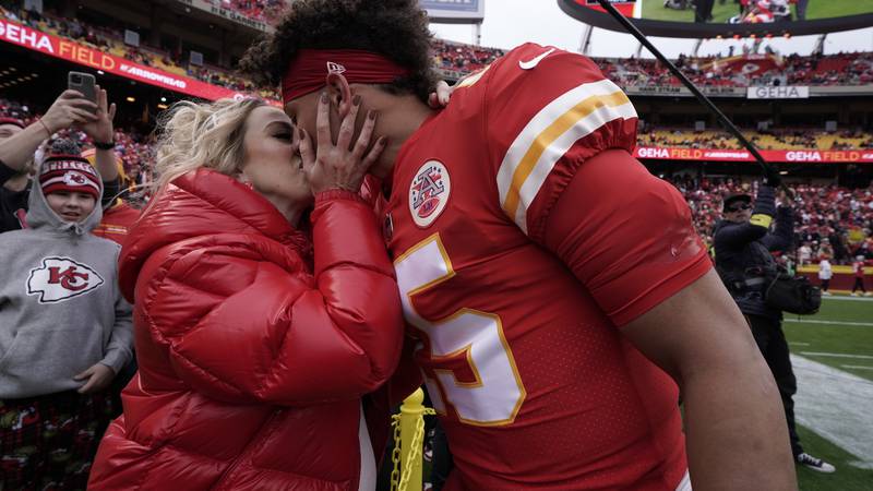 Kansas City Chiefs quarterback Patrick Mahomes (15) gets a kiss from his wife Brittany before...