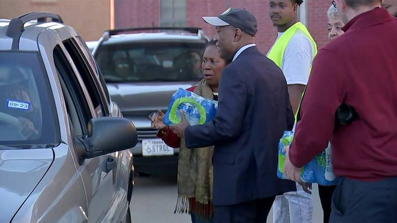 Houston Mayor Sylvester Turner is shown Monday handing out water.